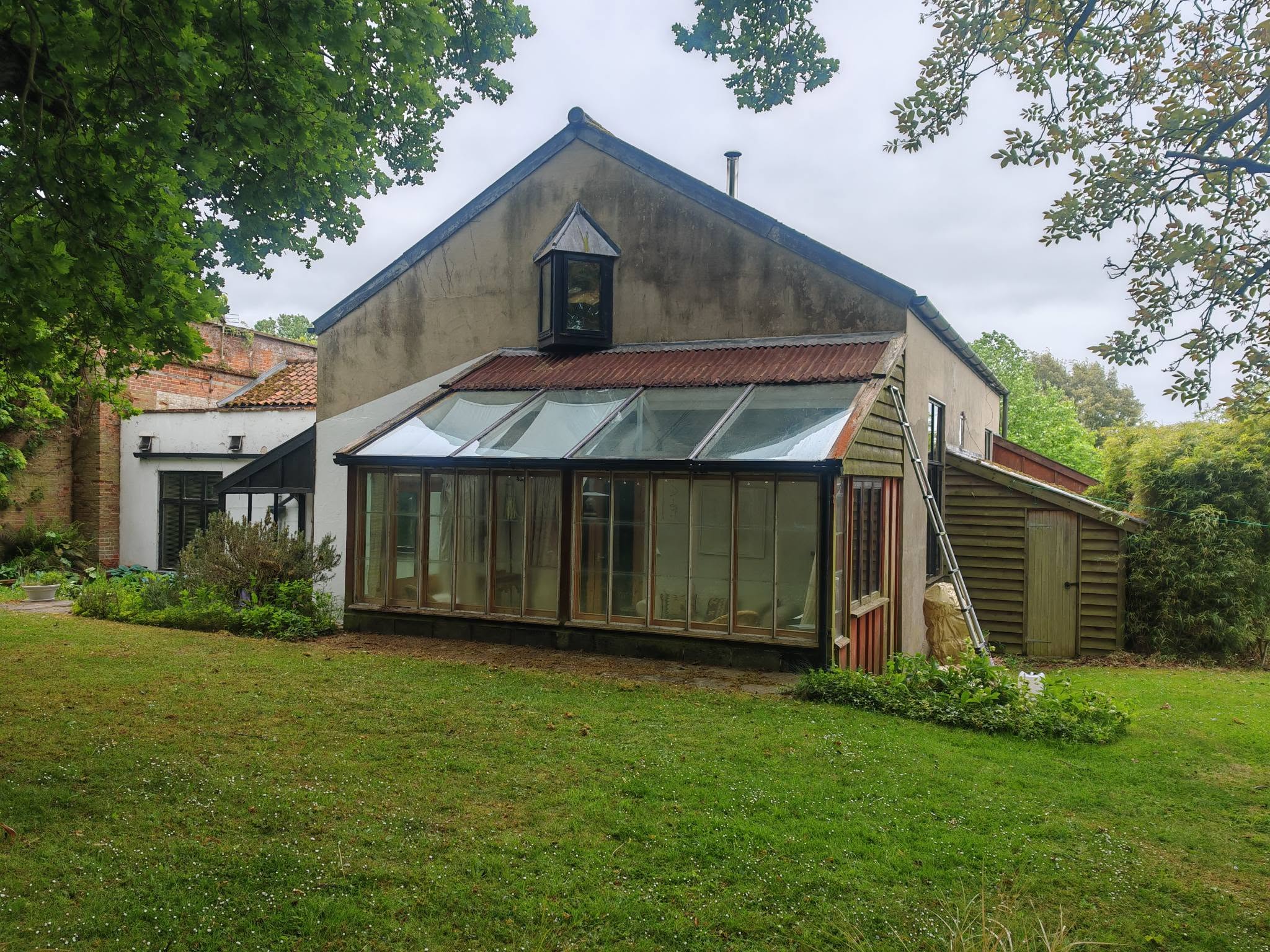 The cleaned conservatory seen from the other side of the garden