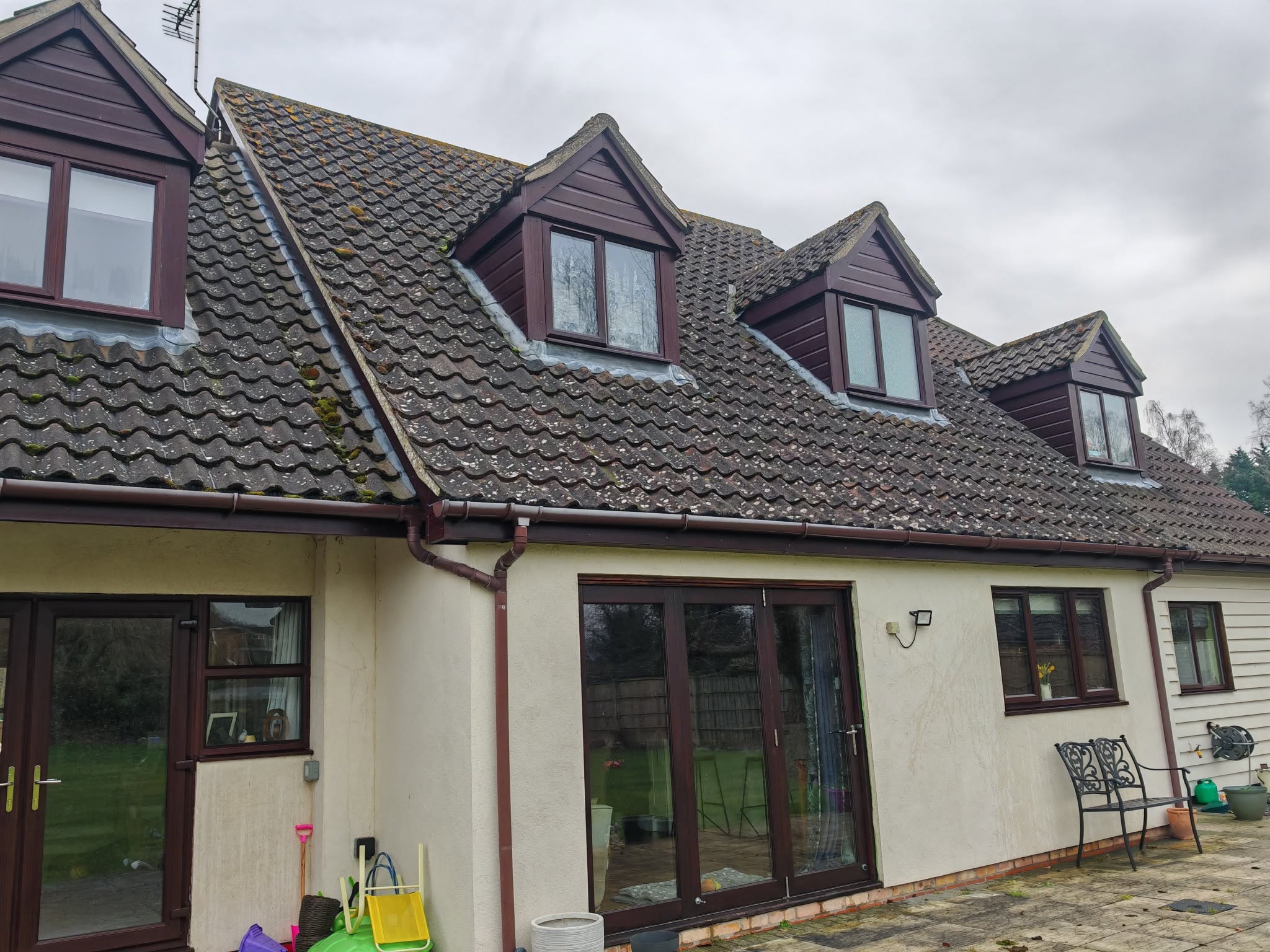 Rear of the same bungalow with dormer windows and patio doors