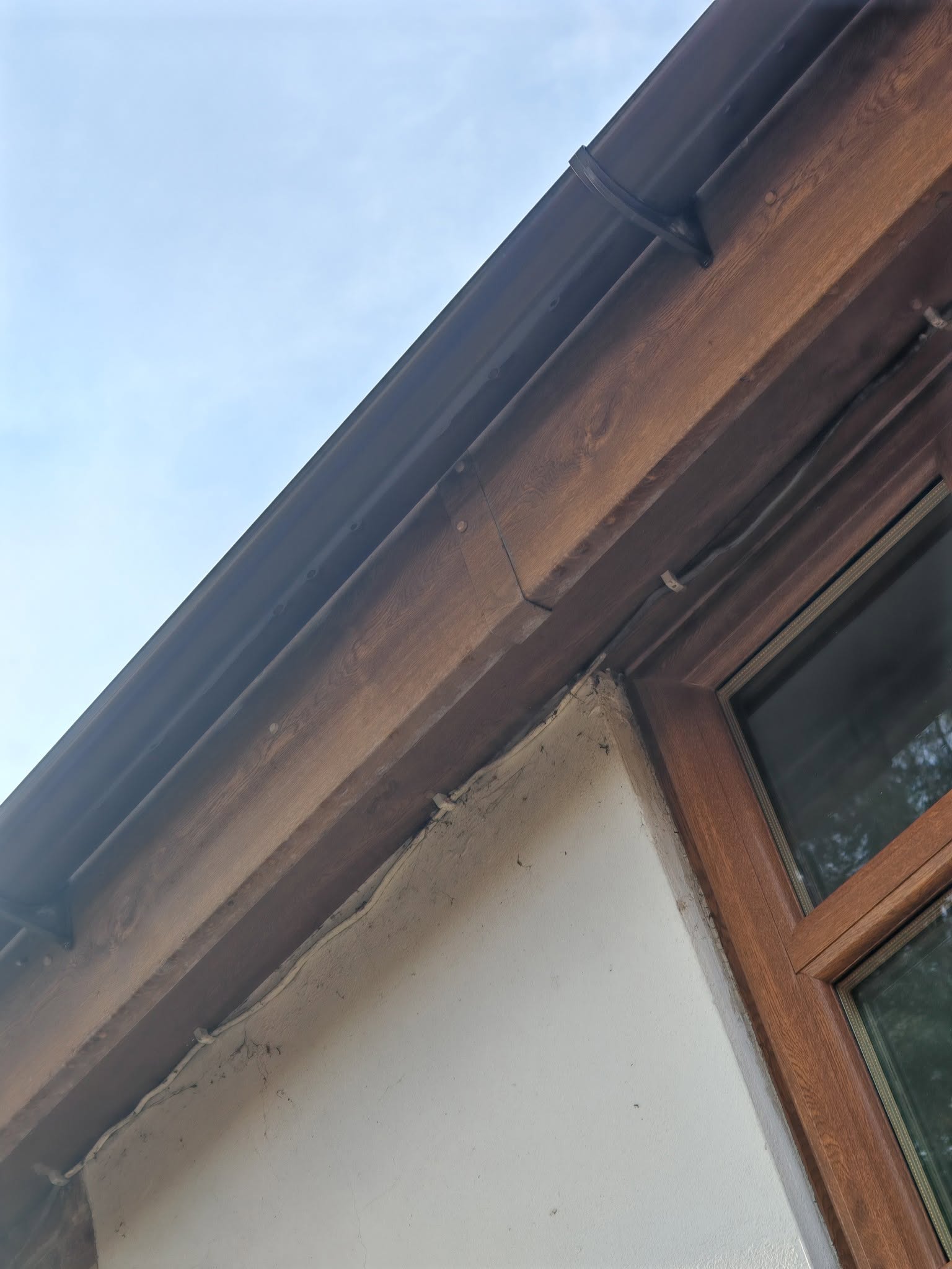 Close-up of a clean gutter and fascia running under a roofline